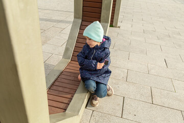 little child having fun at playground in autumn day. Children's outdoor games.