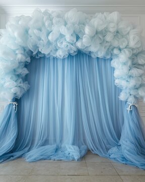 Enchanting pastel blue tulle and cloud-like fabric wedding arch backdrop for dreamy events