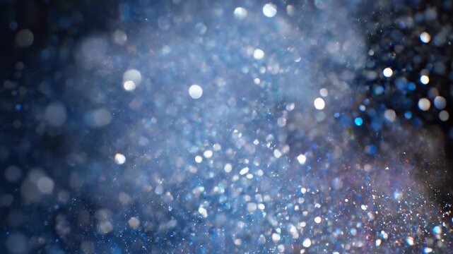 Ultra slow motion capture of glittering blue and silver dust particles dispersing and blurring creating a colorful shimmering afterimage silver dust particles, energy, calm