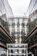 St Pauls Cathedral reflected on the glass facade of One New Change shopping centre, an unusual view blending historic architecture and modern retail in London, England, UK.