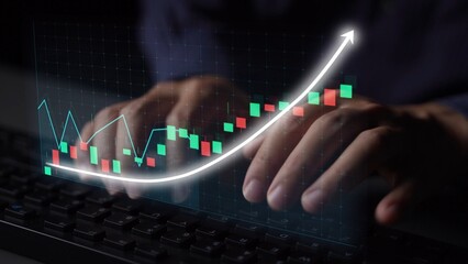 Close-up of hands typing on a keyboard with an overlay of financial graphs and charts. This image represents digital trading and data analysis in modern business environments. Copula