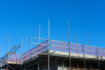 scaffolding on a construction site, under a blue sky