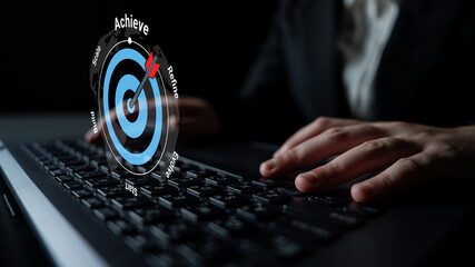 A business professional focuses on a laptop while an overlay graphic shows a target, symbolizing the journey to achievement and success in a modern workspace. Gantry