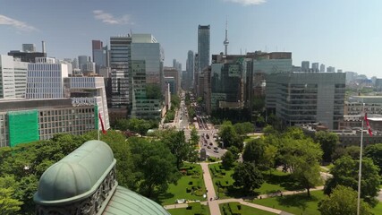 TORONTO, ONTARIO - JUNE 12 2024: Drone scene with historic dome roof beside downtown highrises