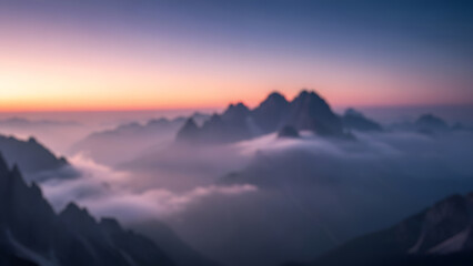 Fototapeta premium Blurred majestic mountain range with peaks rising above a sea of clouds during a serene and colorful sunrise or sunset