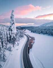 Snowy Road Through a Winter Wonderland - A Serene Aerial View.
