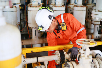 Technician monitor and command by radio to operator on job site in oil and gas industry, Worker in oil and gas industry contact to operation team to check condition of the machine, Maintenance work.