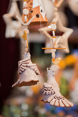 Christmas tree decoration,Close-up of delicate ceramic dove or bird ornaments hanging on beaded strings. Traditional, handcrafted Christmas decoration at the German market