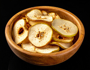 A bowl of dried pear slices. Isolated on a black background.