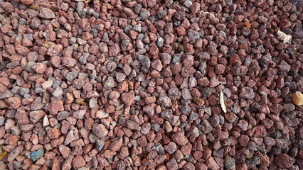 Red volcanic scoria gravel from Jeju Island showcasing natural porous texture