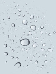 Abstract macro texture of clear blue raindrops on a wet transparent glass surface