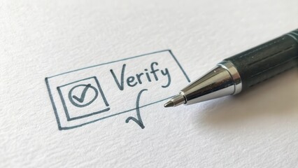 Macro shot of a pen verifying text on paper