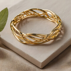 A close-up shot of an intricate golden bracelet, its interwoven design gleaming, showcasing the artistry and elegance of jewelry, against a neutral backdrop.