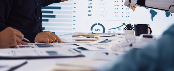 A dynamic scene of humans and a robot collaborating during a business meeting, highlighting data...