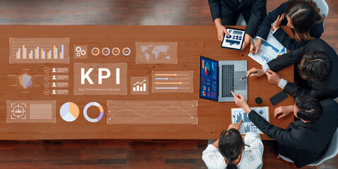 A dynamic business meeting with professionals engaged in analyzing key performance indicators using...