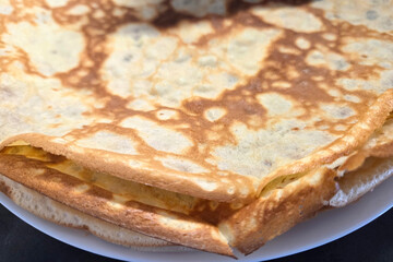 Delicious Golden Crepes on White Plate for Breakfast or Brunch