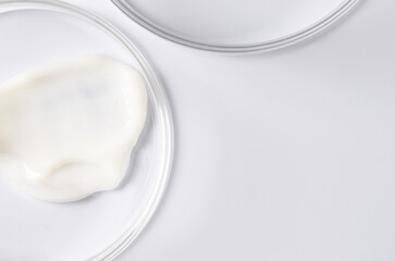 Moisturizing cosmetic skin cream in a Petri dish. Copy space