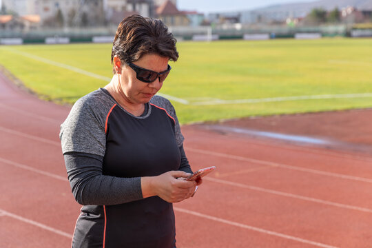 Woman setting phone - Powered by Adobe