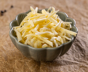 Shredded cheese filling a bowl