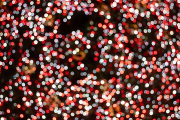 Festive dark theme with red background decorated with Christmas lighting, balls, green Christmas...