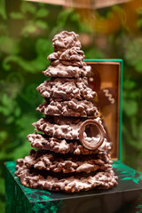 Christmas cookies, decorated with icing and chocolate gingerbread Christmas tree on display in confectionery shop in London, UK