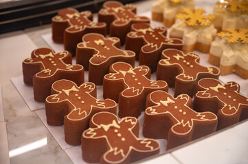 Christmas cookies, decorated with icing and chocolate gingerbread man in confectionery shop in London, UK