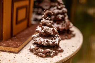 Christmas cookies, decorated with icing and chocolate gingerbread Christmas tree on display in confectionery shop in London, UK