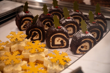 Christmas cookies, decorated with icing and chocolate biscuits gingerbread cakes on display in confectionery shop in London, UK
