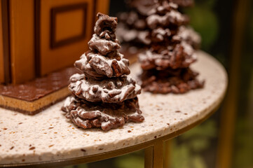 Christmas cookies, decorated with icing and chocolate gingerbread Christmas tree on display in confectionery shop in London, UK