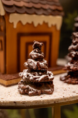 Christmas cookies, decorated with icing and chocolate gingerbread Christmas tree on display in confectionery shop in London, UK