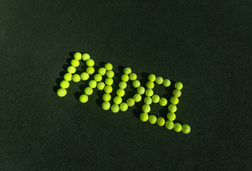 Padel tennis balls. The word padel is formed on the court from balls. Background with copy space. Sport court and ball. Social media template. Promotion for padel and tennis events.