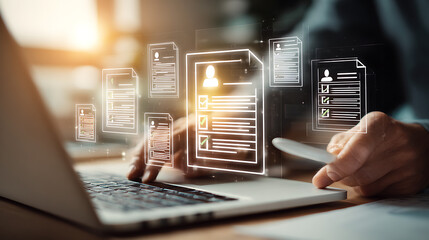 Person typing on laptop reviewing digital documents hands resumes