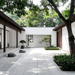 Tranquil courtyard garden with whitewashed walls and a paved path. Lush greenery surrounds a serene space
