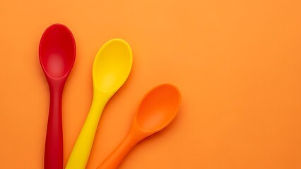 Colorful Spoons on an Orange Background Kitchen Utensils and Bright Colors a Fun and Playful Image for Cooking Baking and Food Related Themes