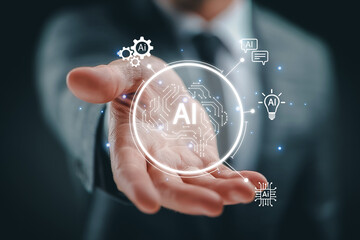 Hand holding glowing AI technology icon representing innovation and digital future.