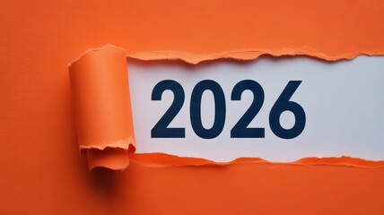 Torn orange paper reveals the year 2026