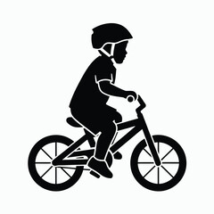 Obraz premium Silhouette of a child riding a bicycle with a helmet