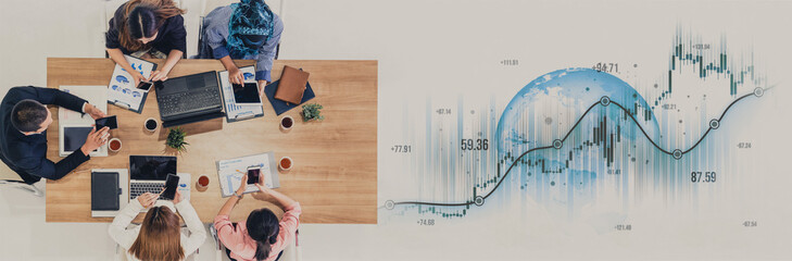 A diverse team works collaboratively around a modern desk, utilizing devices while reviewing financial data and market trends to drive business growth. Scalp