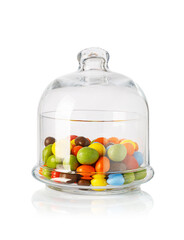 Colorful chocolate candies filling a clear glass cloche jar