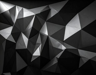 A grayscale, geometric surface composed of triangular planes creating light and shadow patterns