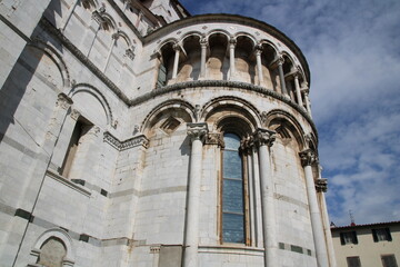 Obraz premium Details of the Romanesque arcade with sculptured capitals and heads on the apse of San Martino Cathedral, Lucca, Italy.