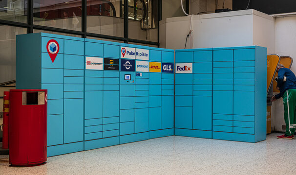Helsinki, Finland - August 08 2025: Blue parcel lockers with multiple delivery service logos.