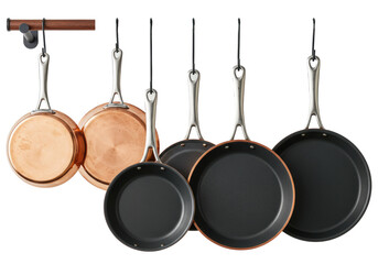 Premium copper frying pans, skillets, and crepe pans hanging on racks against a transparent background. Concept for high-end culinary advertising