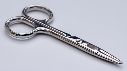Shiny stainless steel medical scissors with sleek design, isolated on white background. scissors feature polished finish and ergonomic handles, ideal for precision cutting