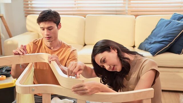 Young asian couple assembly a new furniture at home