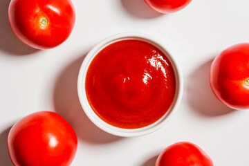 Close-up, top view of ketchup and fresh tomatoes