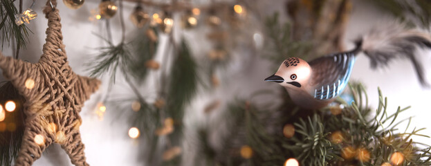 Homemade christmas decoration with pine branches, golden baubles, poinsettia, and festive bokeh...