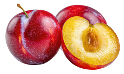 Ripe red plums, one halved revealing juicy yellow flesh and pit