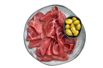 Italian Bresaola Air dried beef slices and marinated olives served on a textured gray plate, captured flat lay with minimal bright backdrop.