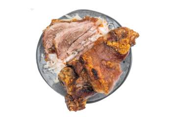Crispy Schweinshaxe roasted pork knuckle showing blistered golden rind, juicy carved interior and shredded cabbage sauerkraut served in clean top-view food styling.